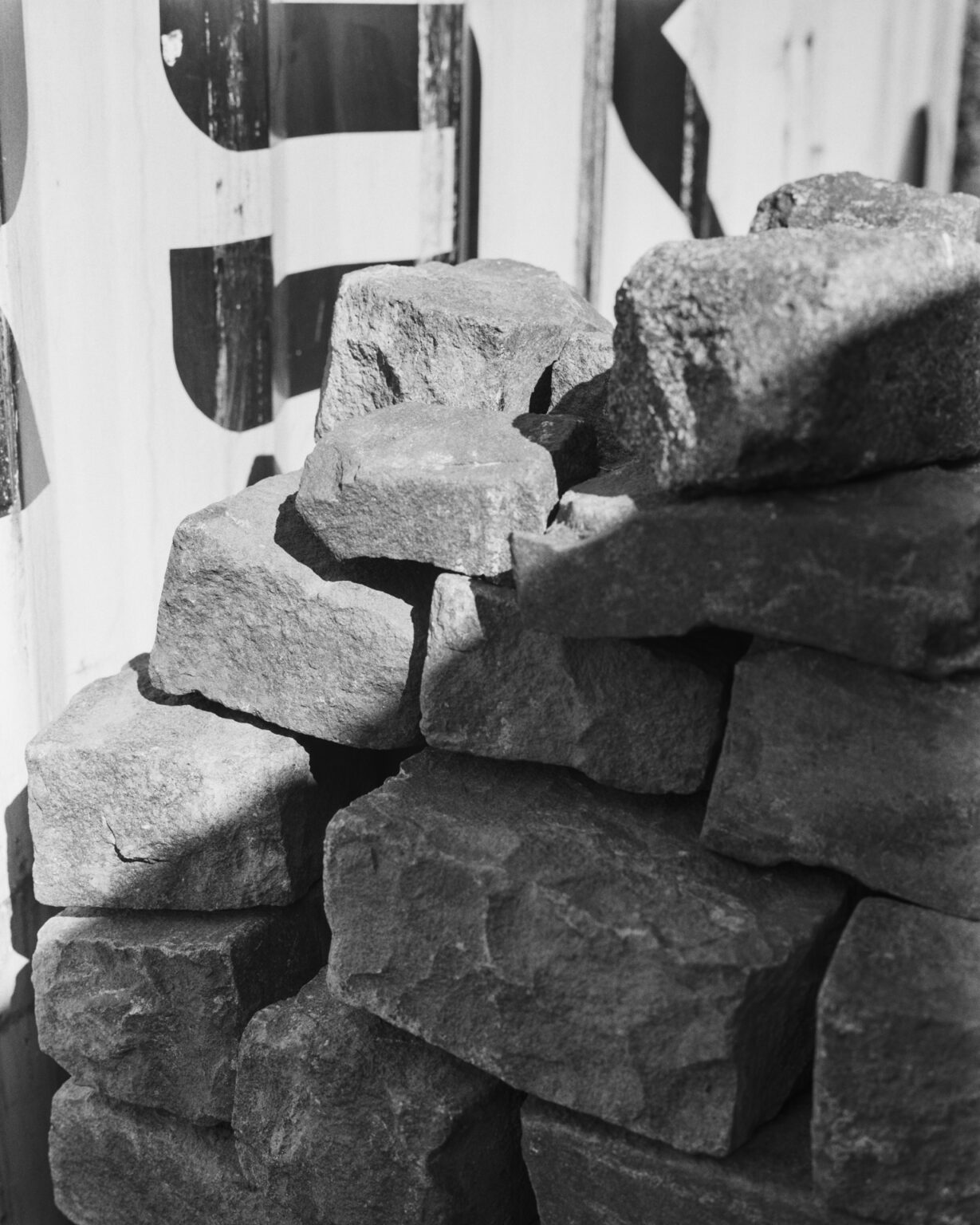 Black and white photograph of two pieces of a brick wall