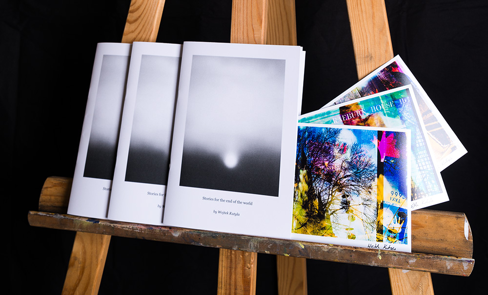 Stories for the end of the world — poetry book displayed alongside photographs